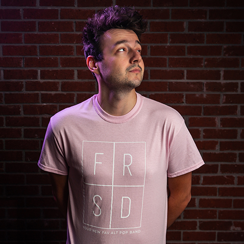 adam fox wearing light pink band t-shirt from the farside